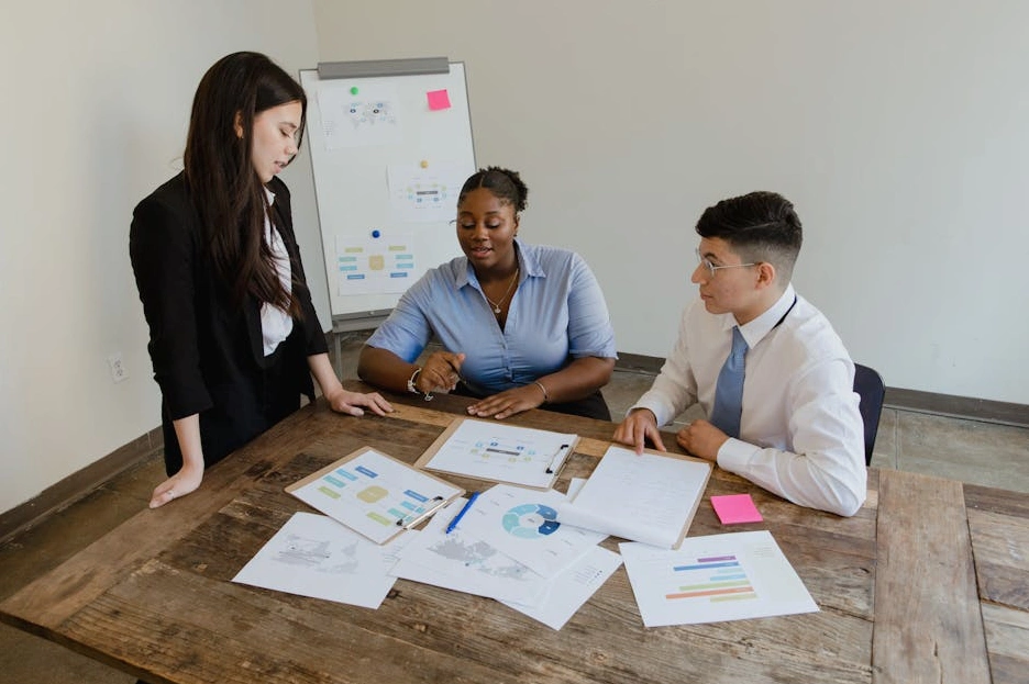A diverse group of professionals engaged in a collaborative discussion in a modern office.